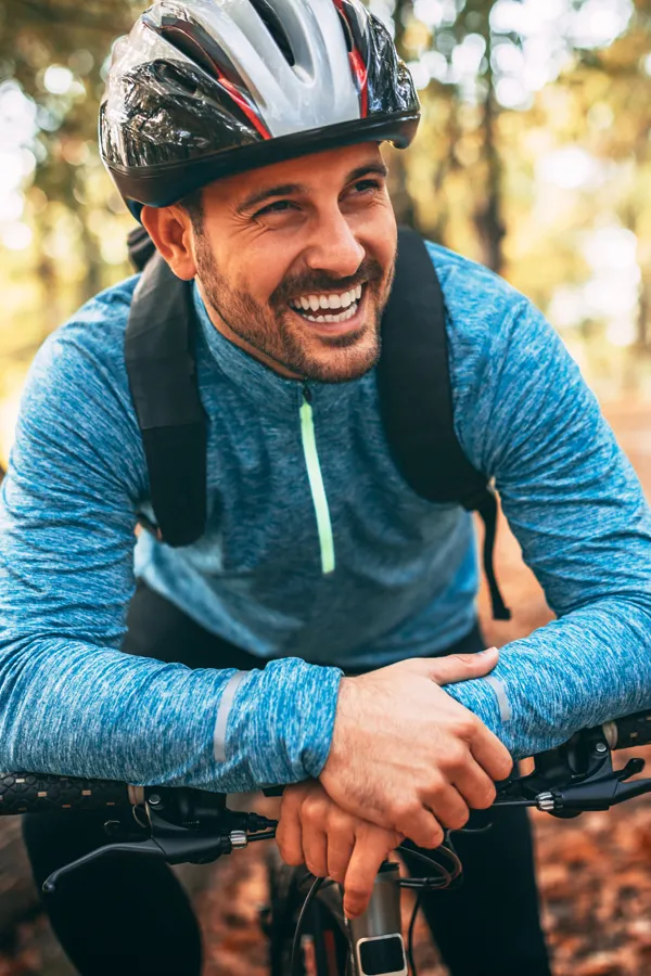 Adrenal-Hormone-Disorder-Treatment A smiling man getting ready for a cycling trip. Get treatment for adrenal hormone disorder from Frank Lanzisera, D.C. in Tampa Bay Metro.