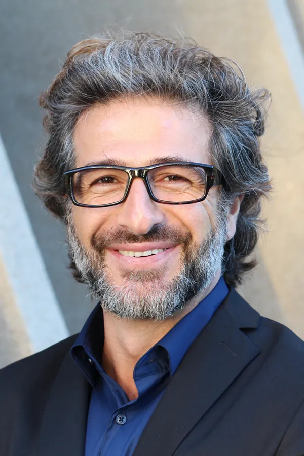 Andropause-and-Low-Testosterone-Treatment A man with glasses, salt and pepper hair and a beard smiling because he received treatment for andropause and low testosterone from Frank Lanzisera, D.C. in Tampa Bay Metro.