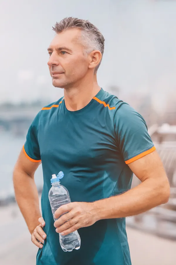 Cardiovascular-Health-Treatment A middle-aged man hydrates after a hard workout. Get cardiovascular health care from Frank Lanzisera, D.C. in Tampa Bay Metro.