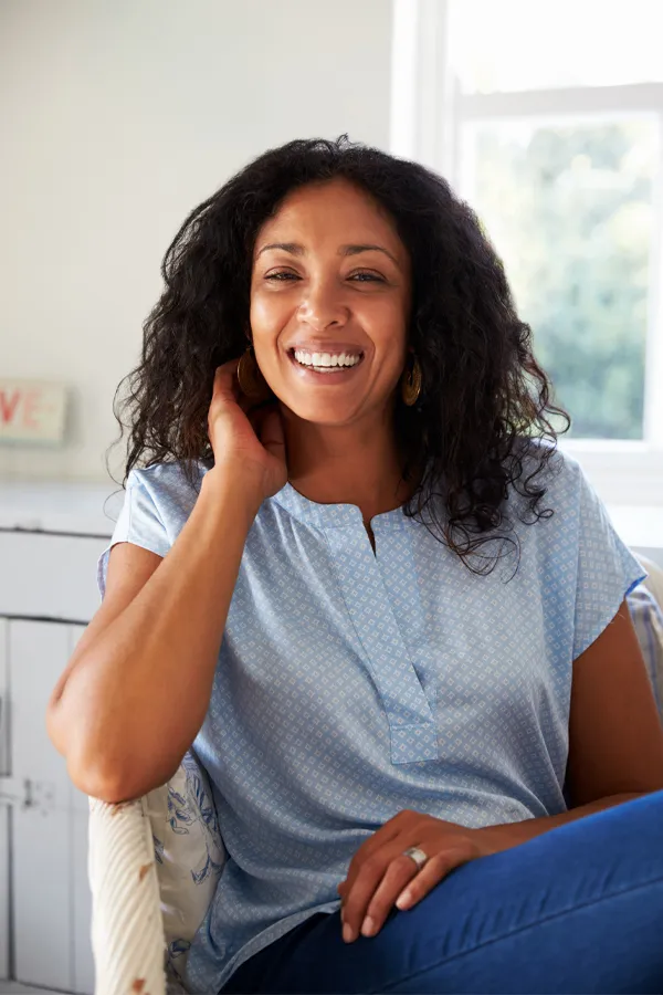 Digestive-IV-Therapy-Treatment A healthy, happy middle-aged black woman sitting in a sunlit room. Get IV Therapy for digestive health from Frank Lanzisera, D.C. in Tampa Bay Metro.