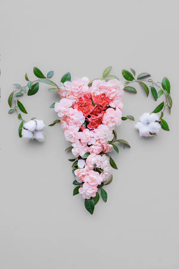 Endometriosis-Treatment Flowers on a gray background, arranged in the shape of the female reproductive system, representing Endometriosis treatment from Frank Lanzisera, D.C. in Tampa Bay Metro.