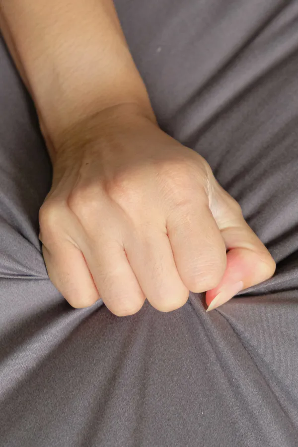 Female-Sexual-Dysfunction-Treatment Close-up of a woman's hand grabbing a sheet, indicating sexual pleasure. Get female sexual dysfunction treatment from Frank Lanzisera, D.C. in Tampa Bay Metro.