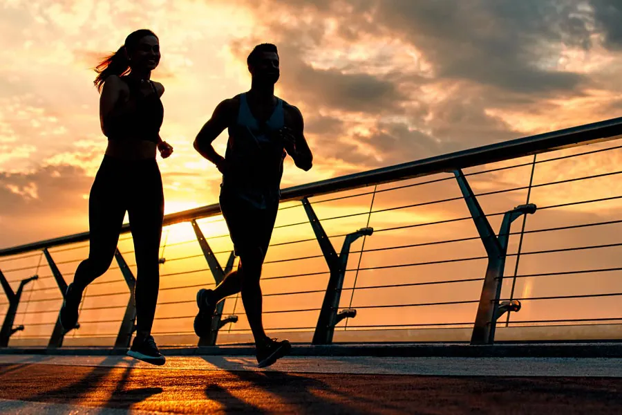 Get-Up-and-Go-IV-Therapy-Clinic A couple on a run, silhouetted by the sunrise. Schedule Get Up & Go IV therapy from Frank Lanzisera, D.C. in Tampa Bay Metro.