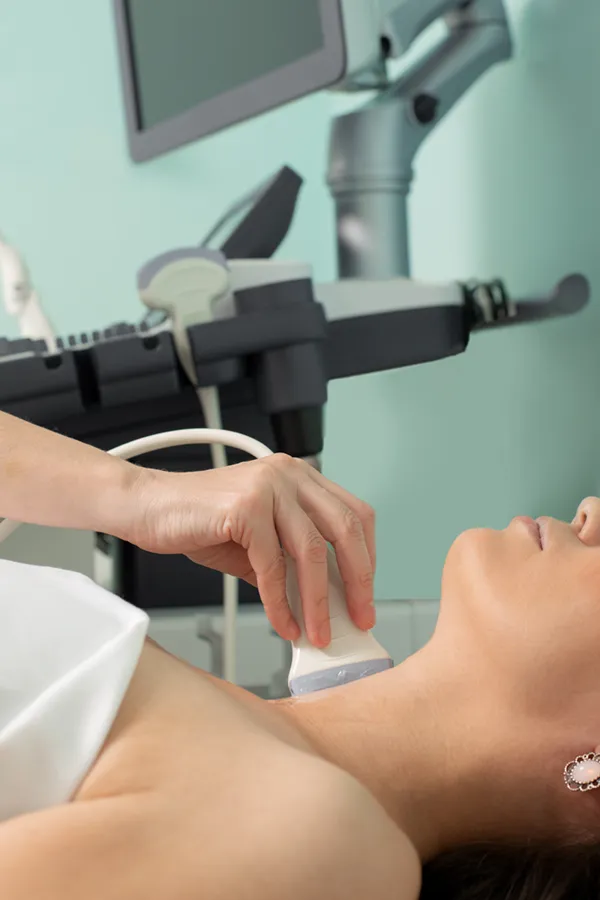 Hashimotos-Thyroiditis-Treatment A woman gets a thyroid scan from a doctor in a clinic. Get help with Hashimoto's Thyroiditis from Frank Lanzisera, D.C. in Tampa Bay Metro.