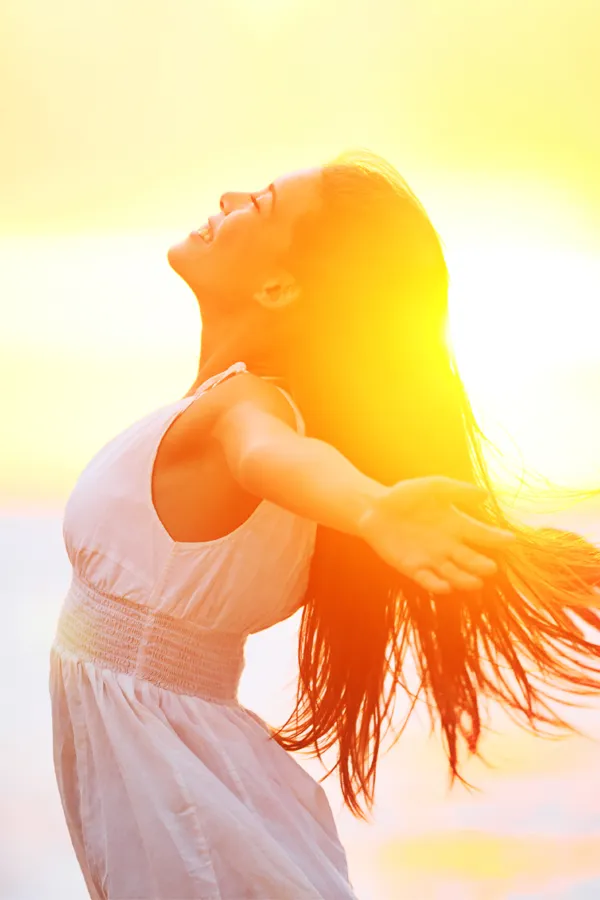 Hydration-IV-Therapy-Treatment A woman opens her arms to the sky at sunrise. Get Hydration IV Therapy from Frank Lanzisera, D.C. in Tampa Bay Metro.