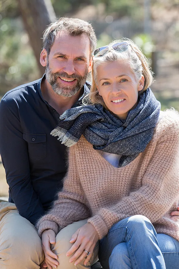 Inflammotory-Bowel-Disease-IBD-Treatment Happy middle-aged couple outdoors wearing cozy fall clothes, smiling calmly. Frank Lanzisera, D.C. is a compassionate IBD specialist in Tampa Bay Metro supporting long-term gut health and symptom relief through functional medicine.
