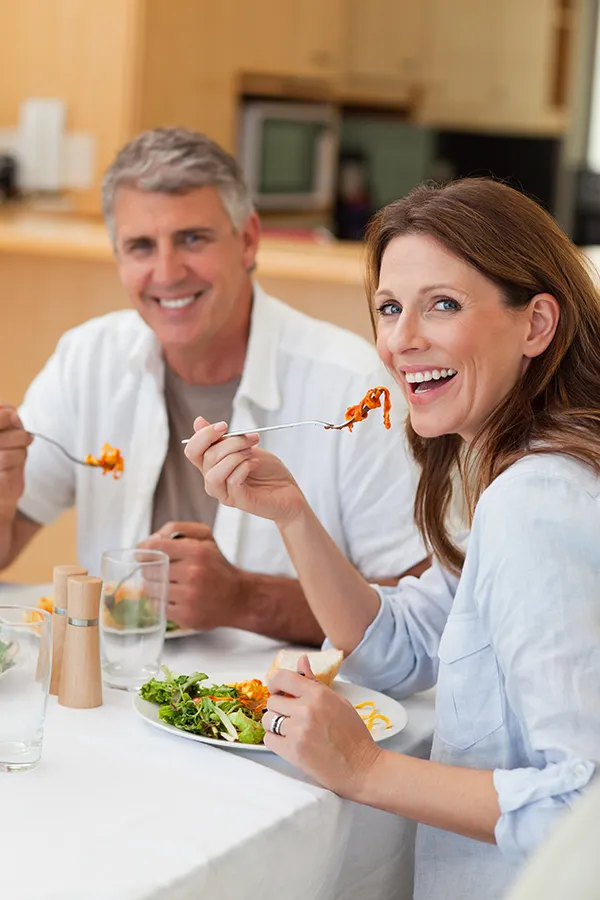 Leaky-Gut-Syndrome-Treatment Improve digestion with Frank Lanzisera, D.C.'s Functional Medicine for Leaky Gut Syndrome care in Tampa Bay Metro, featuring a happy couple enjoying a nutritious lunch at home.
