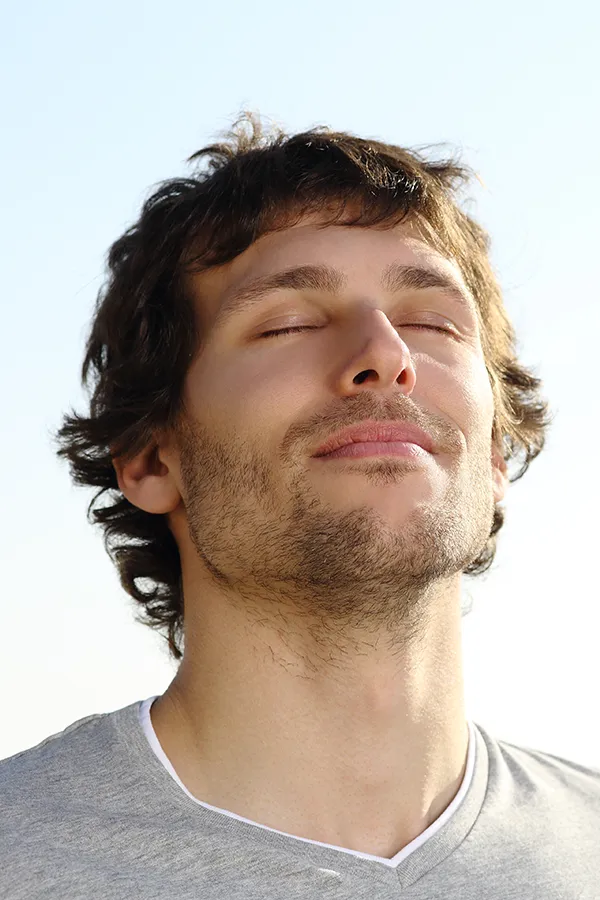 Lupus-Treatment A brown-haired man closes his eyes and breathes in fresh air with his face turned up to the sky. Get treatment for Lupus from Frank Lanzisera, D.C. in Tampa Bay Metro.