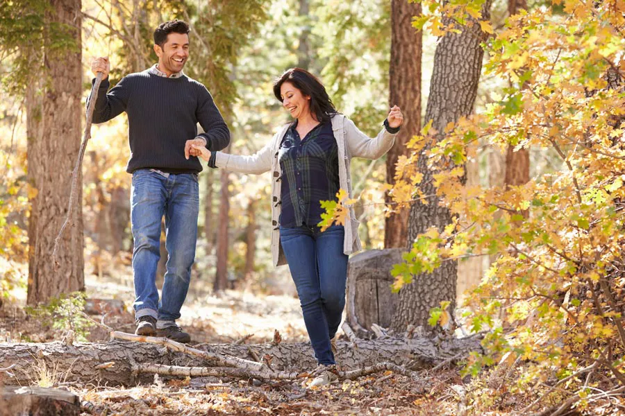 Lyme-Disease-Clinic A couple happily hiking in the forest in fall. Get treatment for Lyme Disease from Frank Lanzisera, D.C. in Tampa Bay Metro.
