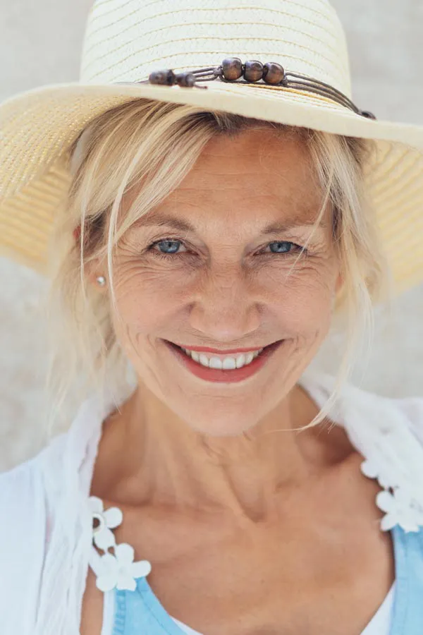 Post-Covid-Clinic A woman in a mask sits outside with her hand on her forehead in pain. Get post-covid treatment from Frank Lanzisera, D.C. in Tampa Bay Metro.