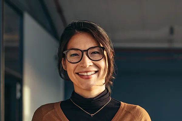 Metabolic-Syndrome-Clinic A brunette woman with glasses smiles in a gray-blue walled office. Get metabolic syndrome from Frank Lanzisera, D.C. in Tampa Bay Metro.