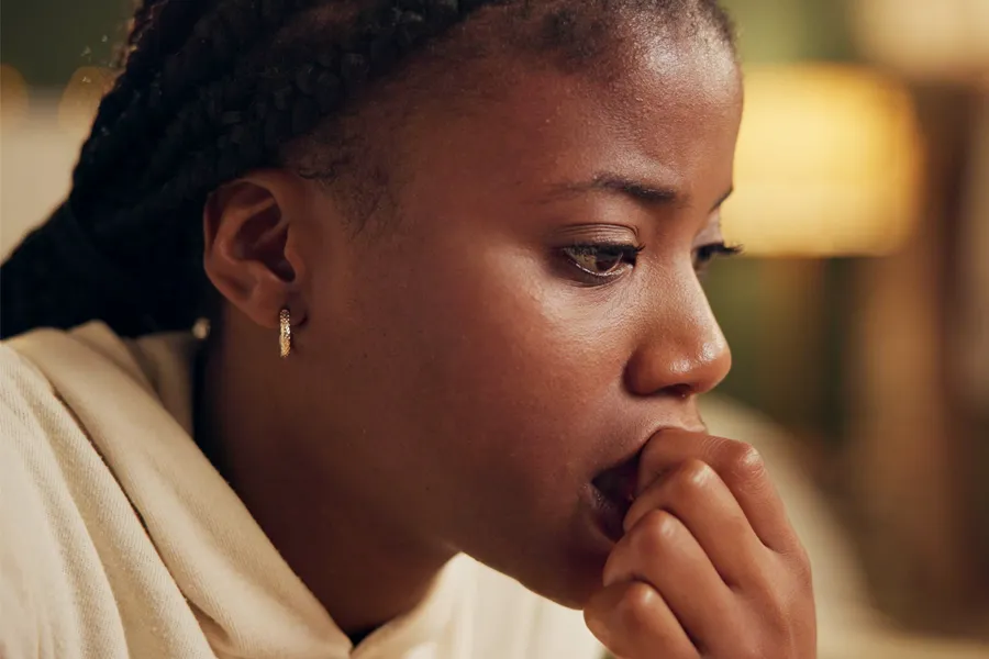 Mood-Imbalance-Clinic A black woman feeling stress bites her nails and looks withdrawn. Get treatment for mood imbalances and stress from Frank Lanzisera, D.C. in Tampa Bay Metro.