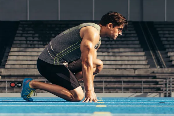 Performance-Recovery-IV-Therapy-Clinic A strong man gets ready to race at the starting line of a track. Schedule IV Therapy for performance recovery relief from Frank Lanzisera, D.C. in Tampa Bay Metro.