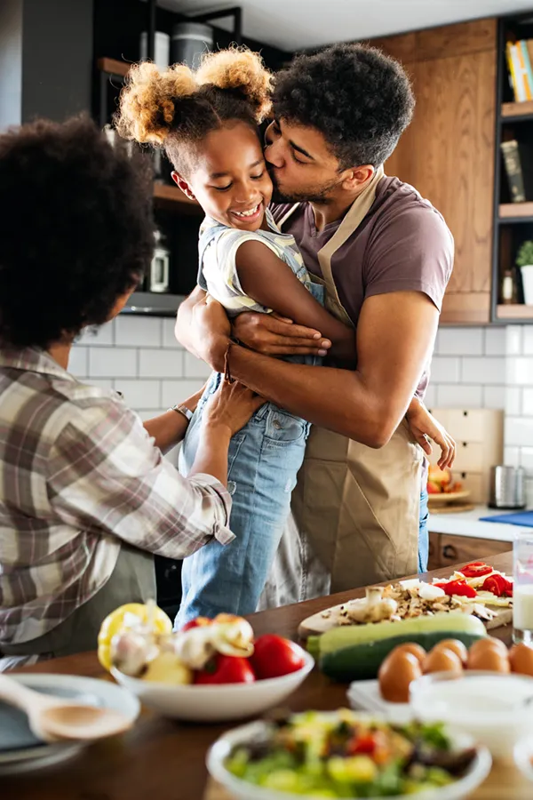 Pre-Diabetes-Treatment A black family happily makes a healthy meal. Get treatment for pre-diabetes from Frank Lanzisera, D.C. in Tampa Bay Metro.