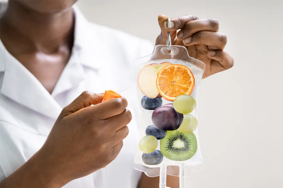 Reboot-IV-Therapy-Clinic A clinician holds an IV bag full of healthy berries. Get Reboot IV therapy from Frank Lanzisera, D.C. in Tampa Bay Metro.