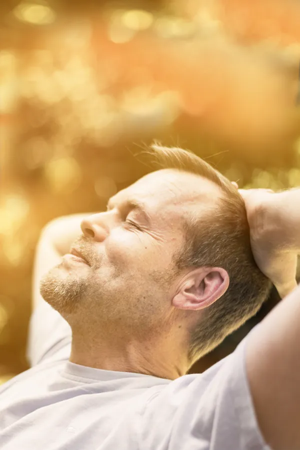 Red-Light-Therapy-Treatment A man relaxes in the sun. Get red light therapy from Frank Lanzisera, D.C. in Tampa Bay Metro.