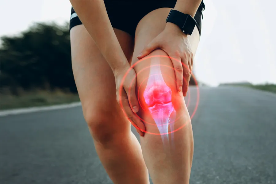 Regenerative-Medicine-for-Knee-Pain-Doctor Close up of a female jogger holding her knee with an illustration of the knee joint with red radiating circles indicating pain, which can be relieved with exosome treatment for knee pain from Frank Lanzisera, D.C. in Tampa Bay Metro.