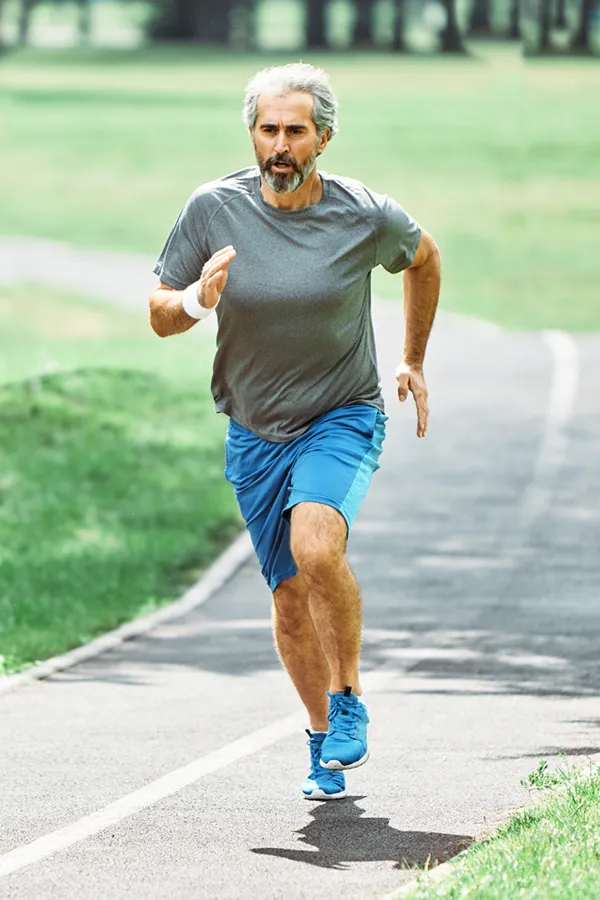 Regenerative-Medicine-for-Knee-Pain-Treatment An older man in gym clothes runs on a trail having had successful exosome treatment for knee pain from Frank Lanzisera, D.C. in Tampa Bay Metro.