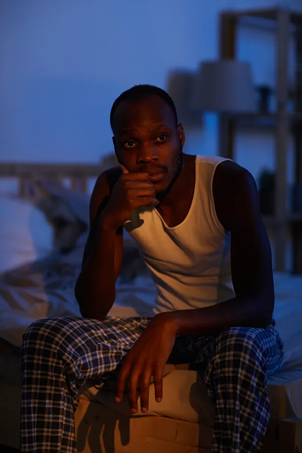Sleep-Disorders-Treatment A man sits on the edge of his bed concerned that he can't sleep. Get treatment for sleep disorders from Frank Lanzisera, D.C. in Tampa Bay Metro.