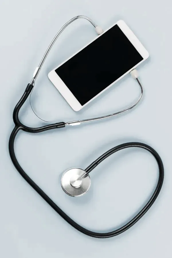 Telemedicine-Treatment A smartphone with a stethoscope attached to it, symbolizing Telemedicine treatment from Frank Lanzisera, D.C. in Tampa Bay Metro.