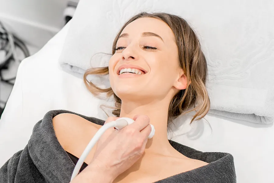 Thyroid-Testing-Clinic A woman gets her thyroid examined with an ultrasound device. Get thyroid testing from Frank Lanzisera, D.C. in Tampa Bay Metro.