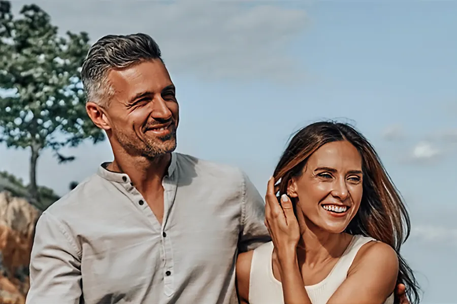 Timeless-IV-Therapy-Clinic A vibrant middle-aged couple walk on the beach. Schedule Timeless IV therapy from Frank Lanzisera, D.C. in Tampa Bay Metro.